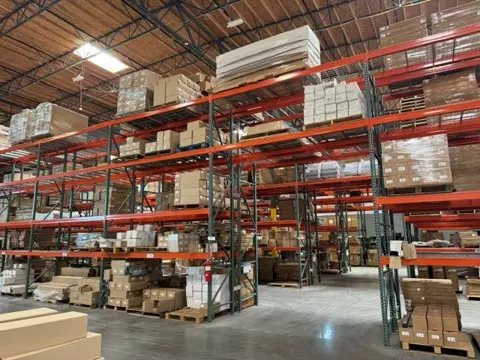 Warehouse racks holding stage platforms and components at the IntelliStage facility in Sparks
